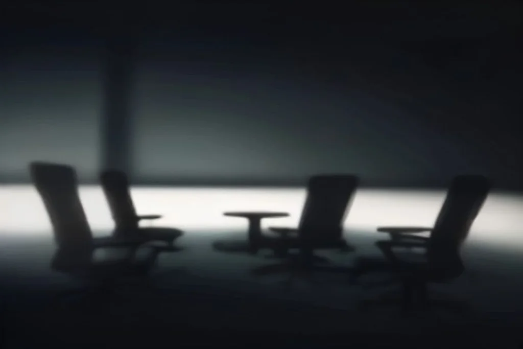 Dark gaming setup silhouette with RGB-lit empty chairs, no screens content