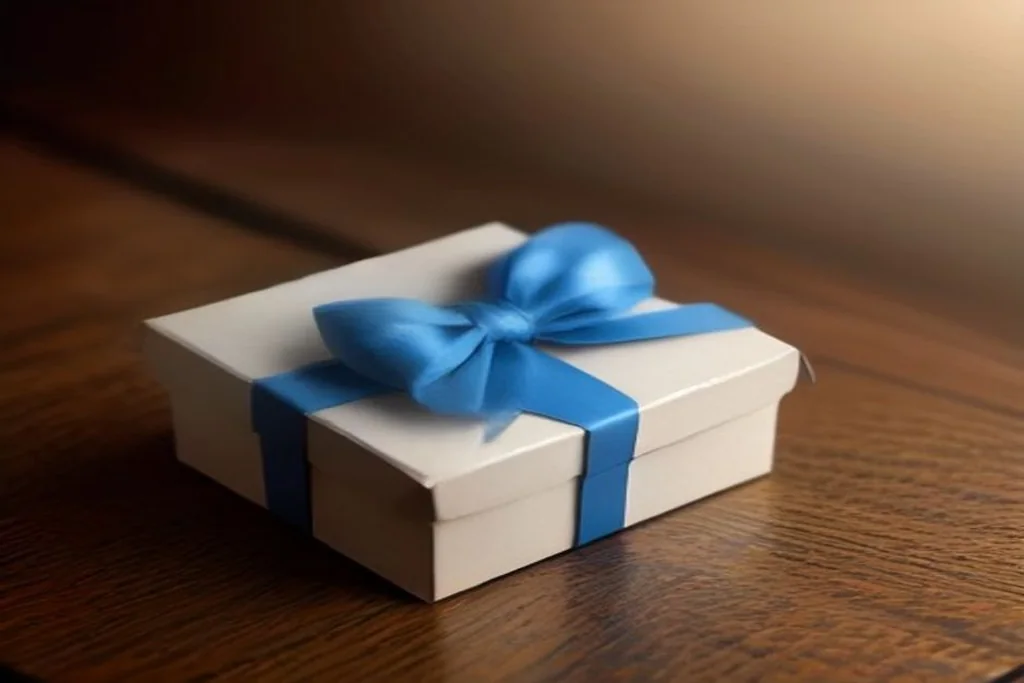 Closed gift box with a blue ribbon on a dark wooden table